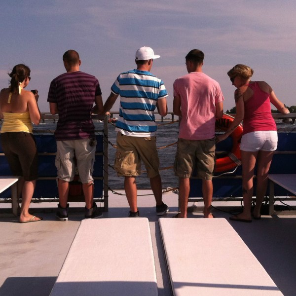 Group standing at the end of boat