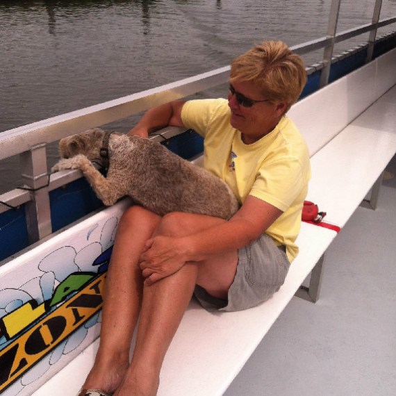 Woman with dog on boat