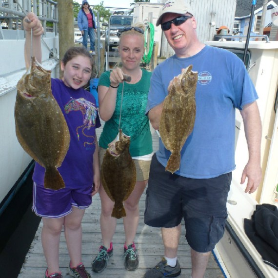 Group holding up fish